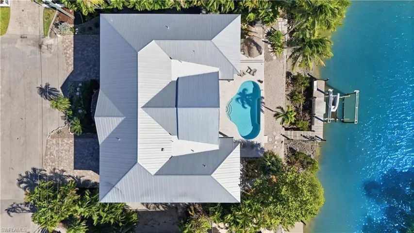 View of subject property featuring a pool - Virtually Edited Image