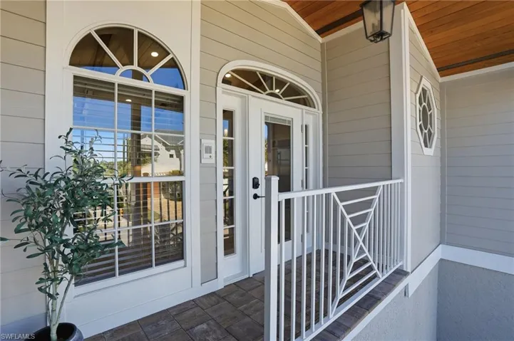 Entrance to property featuring covered porch - Virtually Edited Image