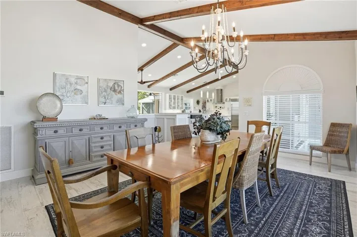 Dining area with beamed ceiling, high vaulted ceiling, recessed lighting, and light wood-type flooring - Virtually Edited Image