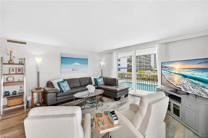 The sliders on the side of condo opens to the community pool and southern beach views -image may have been digitally enhanced