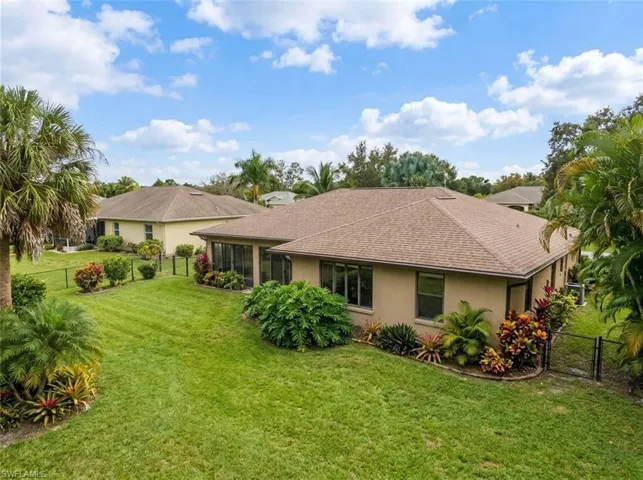 Expansive lawn with mature trees and established landscaping