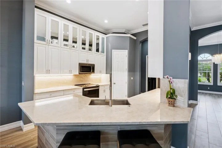 Kitchen featuring peninsula, stainless steel appliances and more.