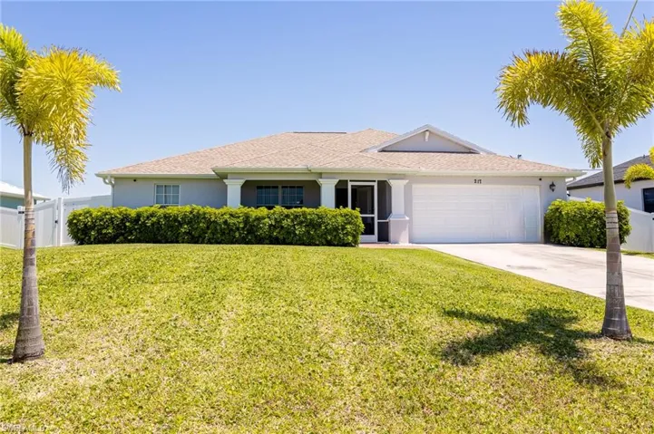 Ranch-style house with a front lawn and a garage