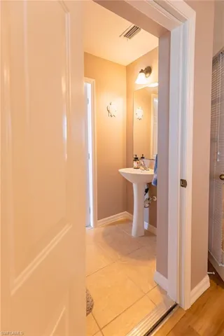 Bathroom featuring tile patterned flooring and sink