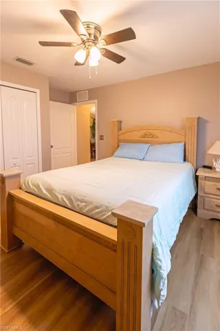 Bedroom featuring ceiling fan, a closet, and hardwood / wood-style flooring