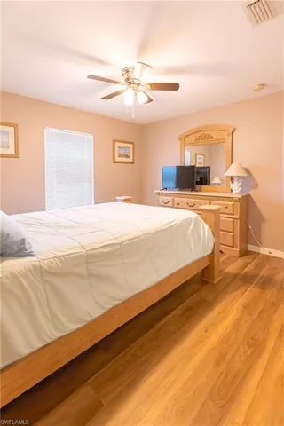 Bedroom featuring ceiling fan and light hardwood / wood-style floors