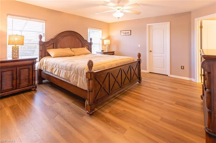 Bedroom with ceiling fan and light hardwood / wood-style flooring