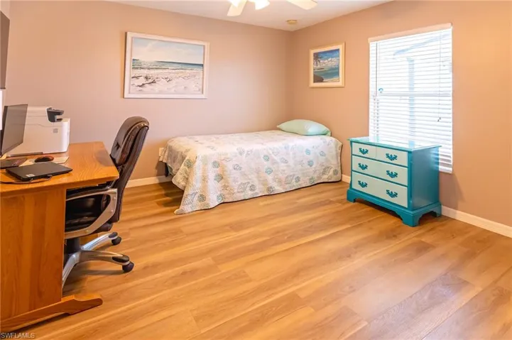 Bedroom with light hardwood / wood-style floors and ceiling fan