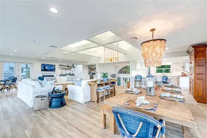 Dining room featuring a chandelier, wood tiled floors, recessed lighting, coffered ceiling, and a fireplace