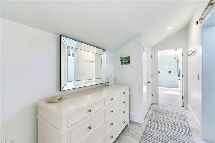 Hallway to Master Bath with lofted ceiling and recessed lighting