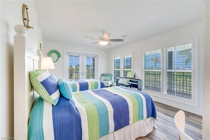1st floor Bedroom featuring wood finished floors, a ceiling fan, and french doors