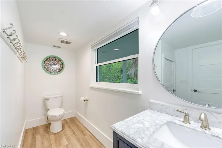 Bathroom featuring vanity, wood tiled floors, and recessed lighting