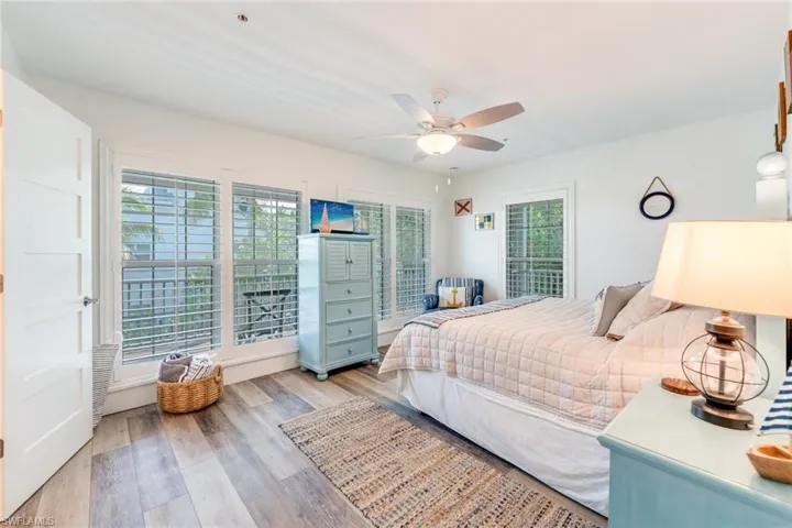 1st floor Bedroom with light wood finished floors and a ceiling fan