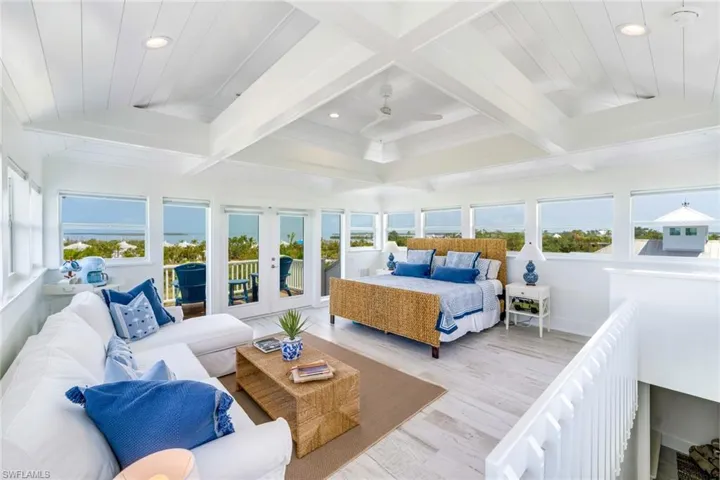3rd floor Master bedroom with multiple windows, wood finished floors, recessed lighting, french doors, and access to outside deck with 360 degree view