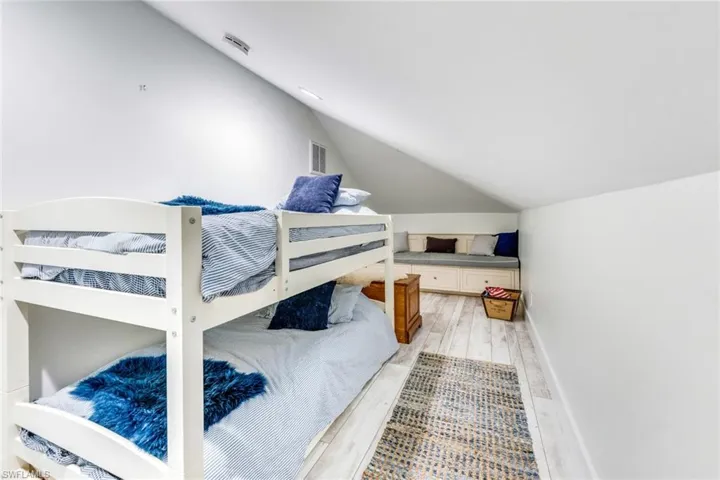 Bedroom featuring vaulted ceiling and light wood finished floors