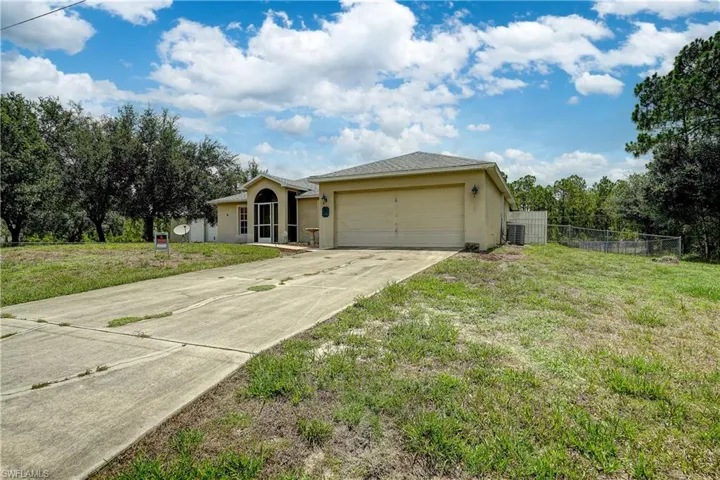 A long driveway and a 2 car garage