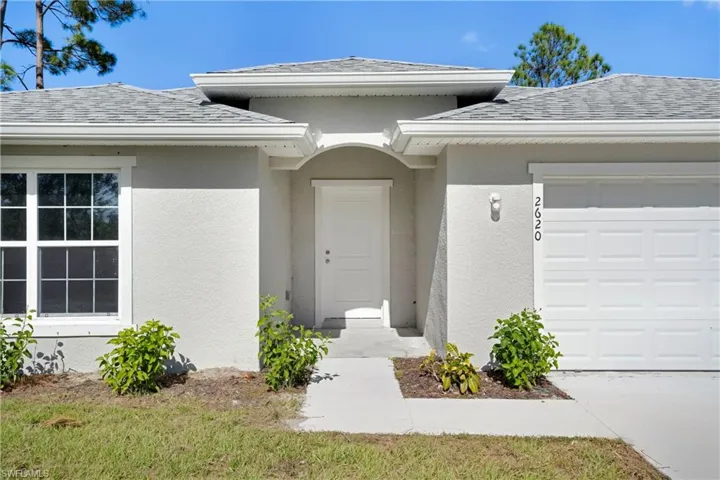 Doorway to property with a garage