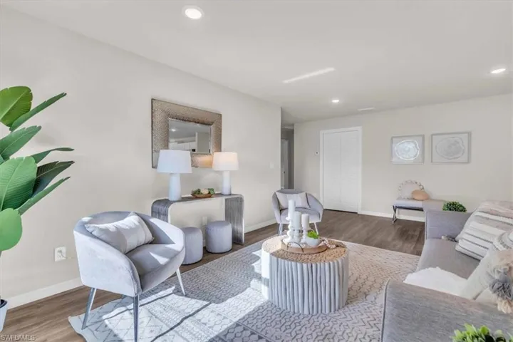 Living room with hardwood / wood-style flooring