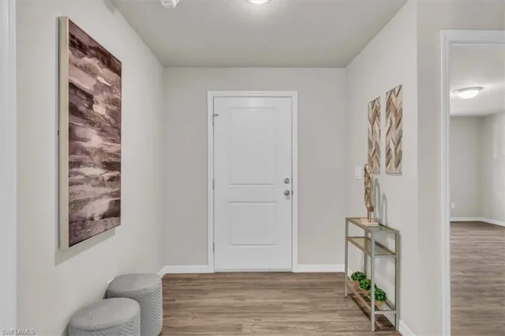 Entrance foyer with light wood-type flooring