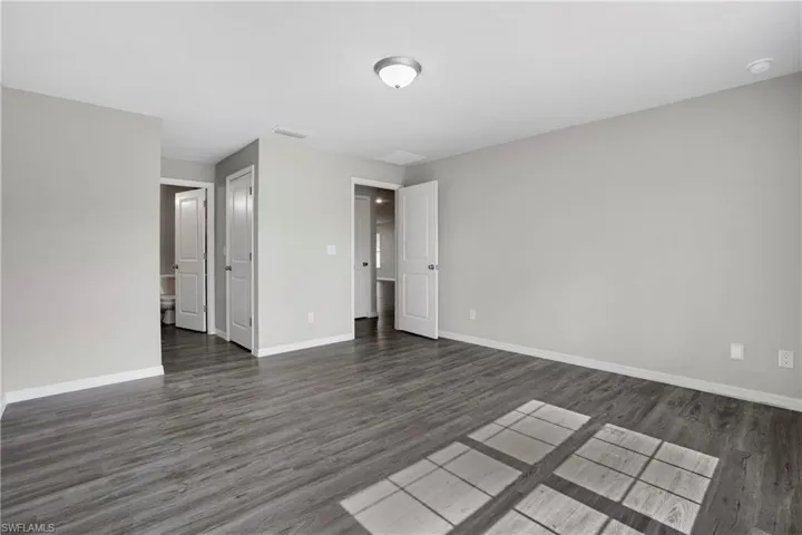 Primary Suite featuring laminate wood-type flooring