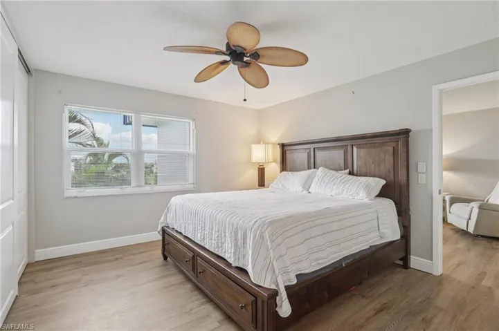 Bedroom featuring light LVP floors and ceiling fan