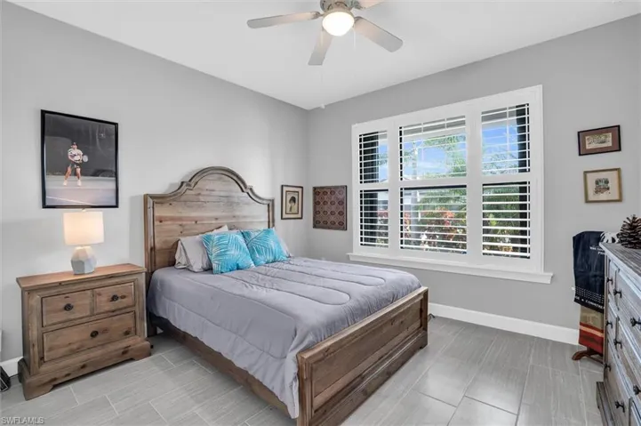 Bedroom featuring baseboards and ceiling fan