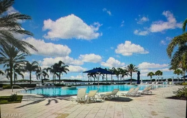 Community pool with a patio
