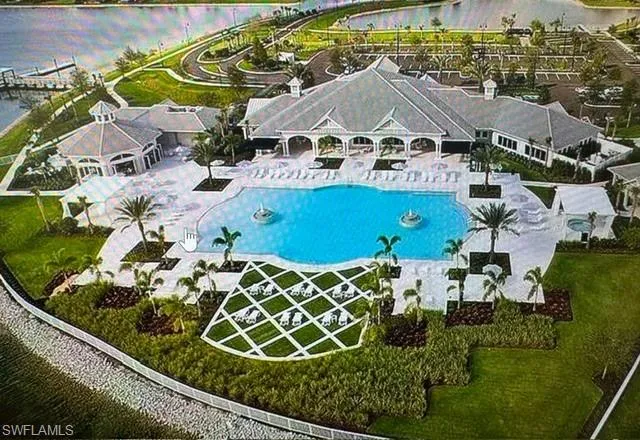 Bird's eye view of a pool and a nearby body of water
