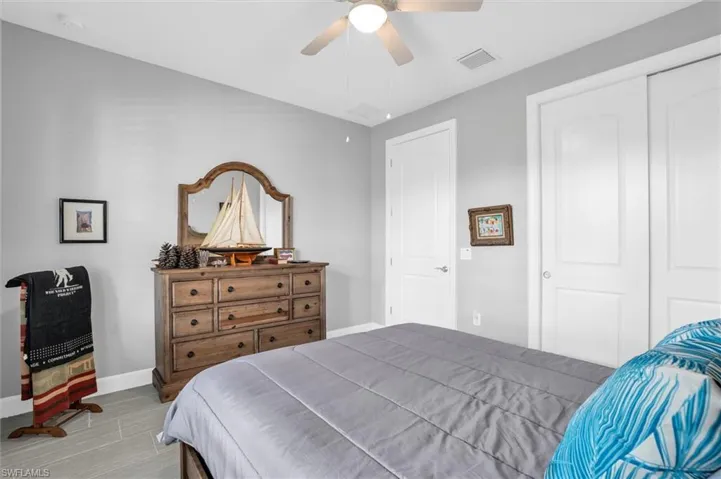 Bedroom with baseboards, a ceiling fan, and wood finished floors