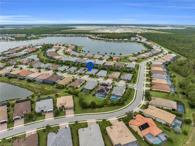 Aerial overview of property's location with a large body of water and nearby suburban area