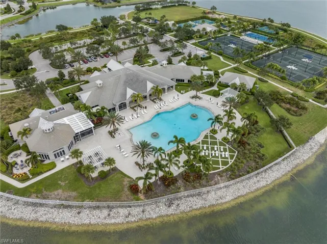 Aerial view of a pool area and a large body of water