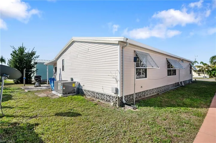 View of property exterior with a yard