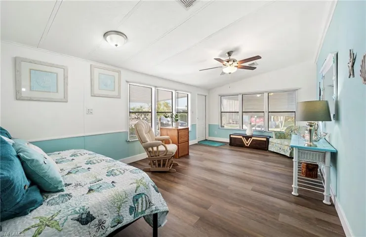 Bedroom with dark wood-type flooring and vaulted ceiling