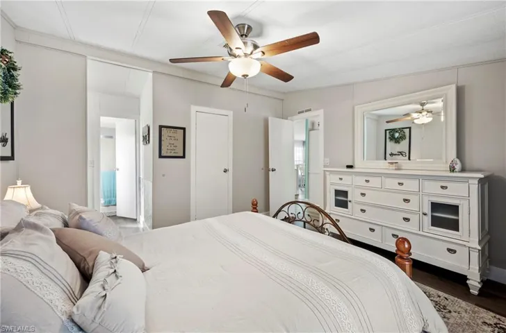 Bedroom with ceiling fan and dark hardwood / wood-style flooring