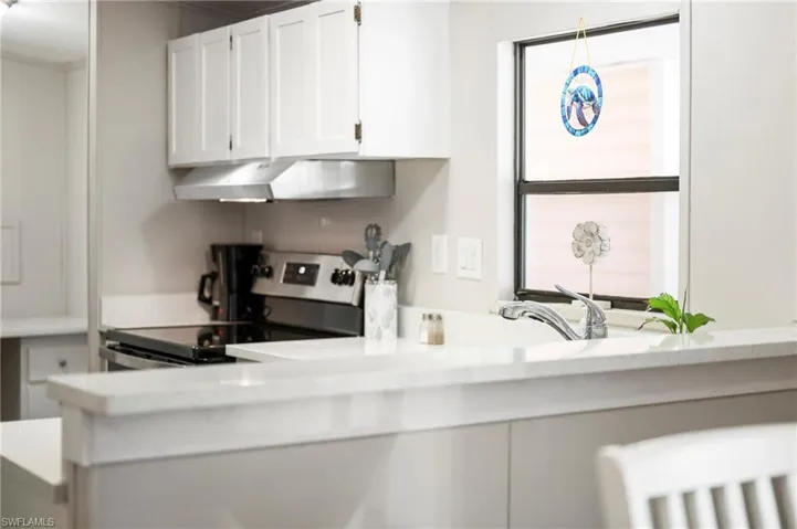 Kitchen with white cabinetry and stainless steel electric range oven