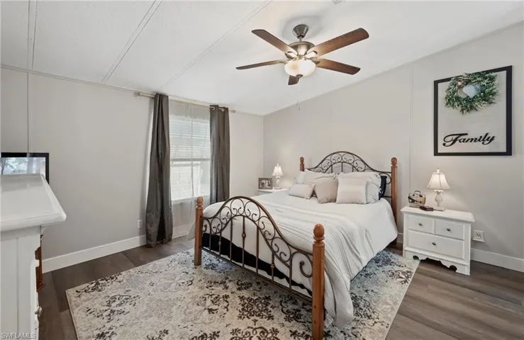 Bedroom featuring ceiling fan and dark hardwood / wood-style floors