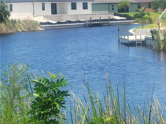 Property view of water with a boat dock