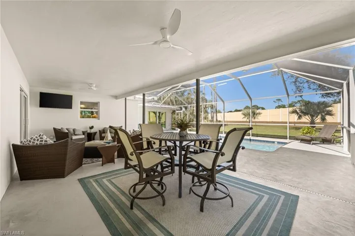 Relax, dine, and entertain in style beneath the covered lanai ,offering breezy comfort and a seamless connection to the heated pool and backyard.