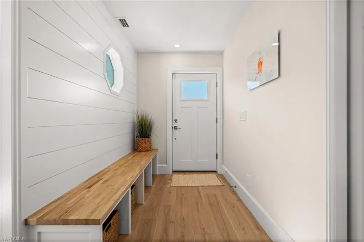 An inviting entryway designed with intention, blending coastal textures and craftsmanship to create a serene first impression.