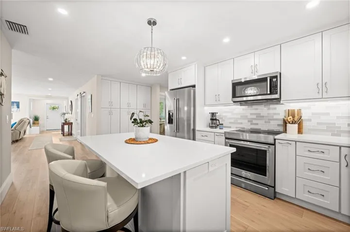 At the center of the kitchen, a spacious island invites connection, ideal for morning coffee, casual meals, or conversation while cooking unfolds around you.