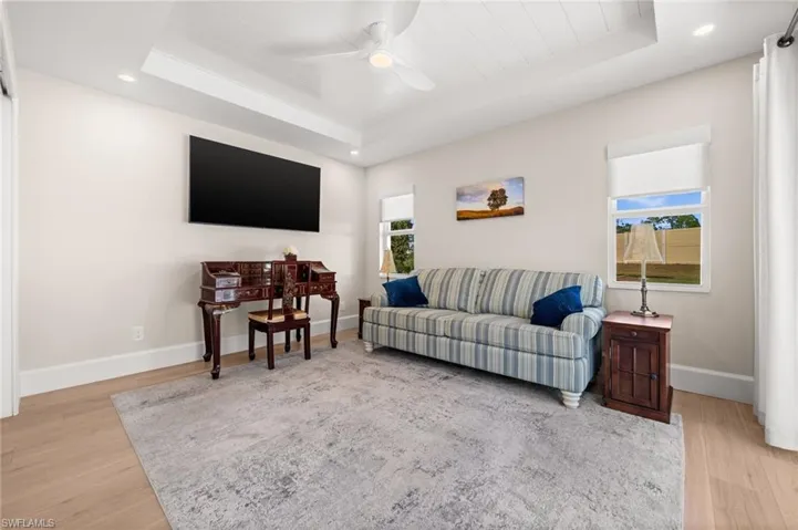 Designed for adaptability, this serene sitting room features elegant ceiling detail, wide-plank flooring, and plenty of space to live, work, or unwind.