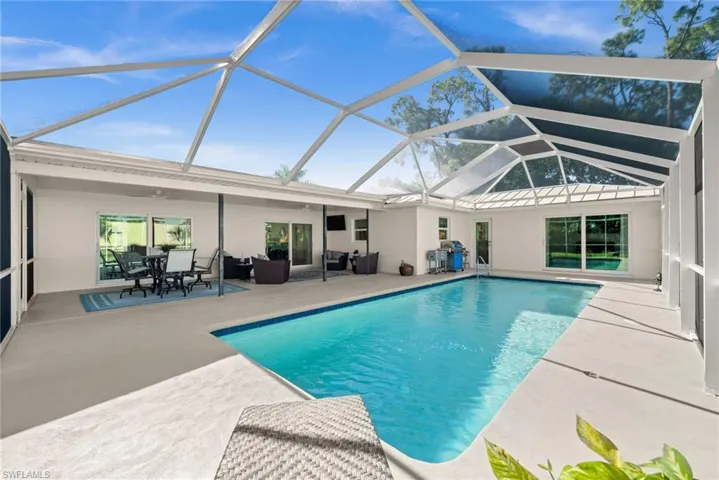 Dive into tranquility, this expansive pool area invites lounging, floating, and seamless Florida indoor-outdoor living.