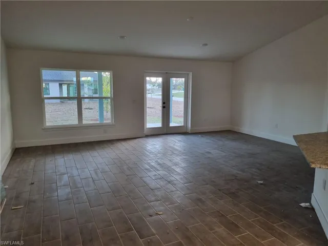 Spare room featuring wood tiled floors and french doors