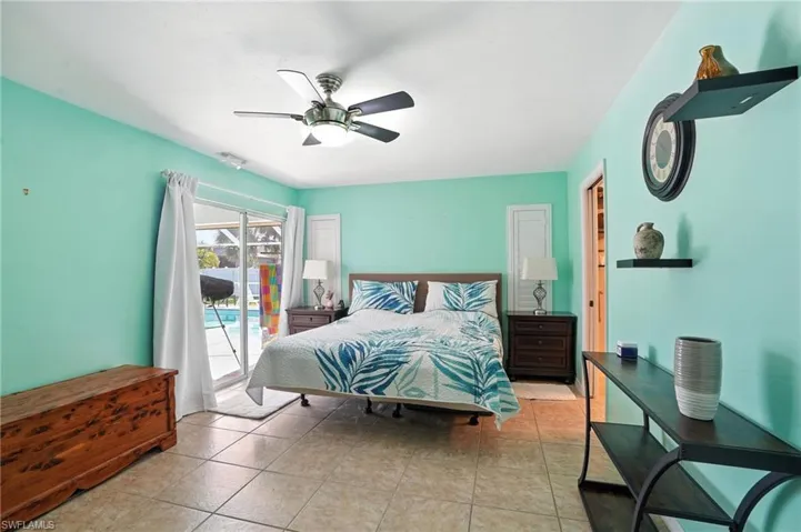 Living area featuring light tile patterned flooring, ceiling fan, vaulted ceiling, and recessed lighting