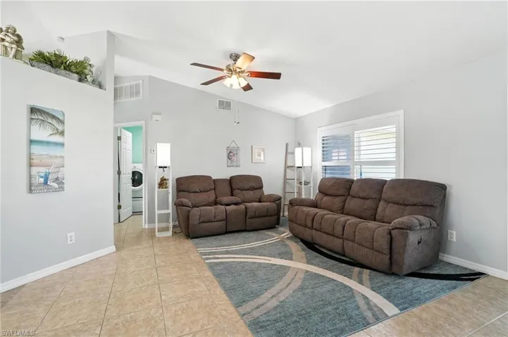 Bedroom with multiple windows, tile patterned floors, and a ceiling fan