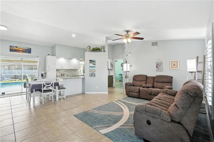 View of pool with a fenced backyard, a patio, grilling area, and a lanai