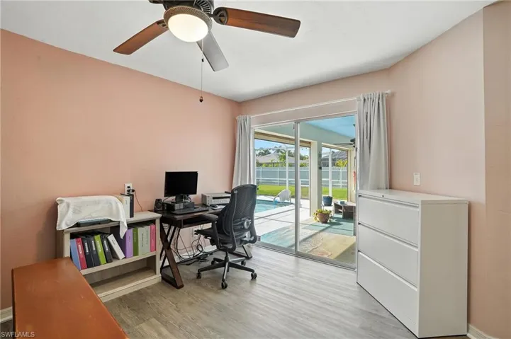 Back of property with a fenced backyard, stucco siding, an outdoor pool, a patio, and glass enclosure