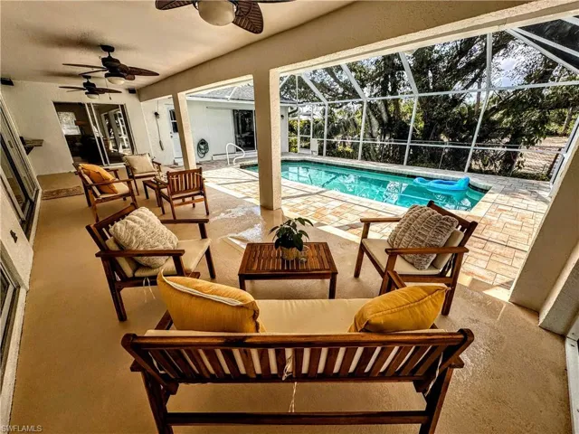 Outdoor pool with outdoor lounge area, a lanai, a patio, and a ceiling fan