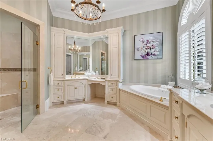 Beautiful, travertine floors, dual vanities and large, walk-in shower, make for a spacious bathroom.