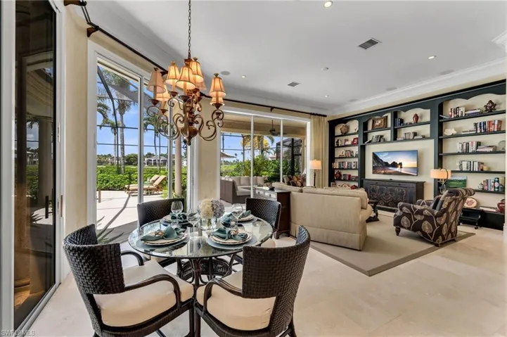 The dinette just off the kitchen and family room has beautiful views out to the pool and outdoor kitchen...